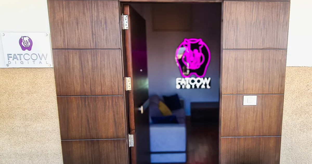 Brown door entrance to a Digital Marketing agency showing the LED logo inside.